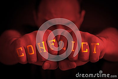 CONFLICT written on an angry manâ€™s fists Stock Photo